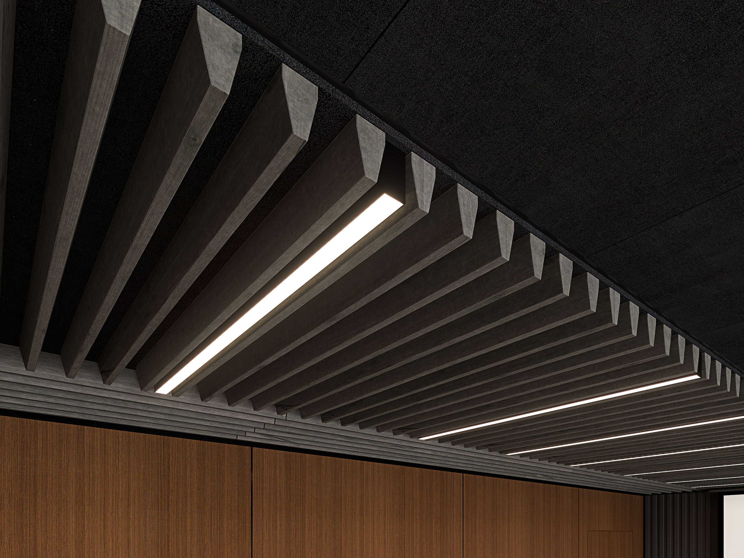 A modern ceiling design featuring dark, angled acoustic felt ceiling slats with embedded strip lighting running parallel. The dark ceiling contrasts with the light wooden wall panels below and incorporates an acoustic felt ceiling frame for enhanced sound absorption. The overall aesthetic is sleek and contemporary.