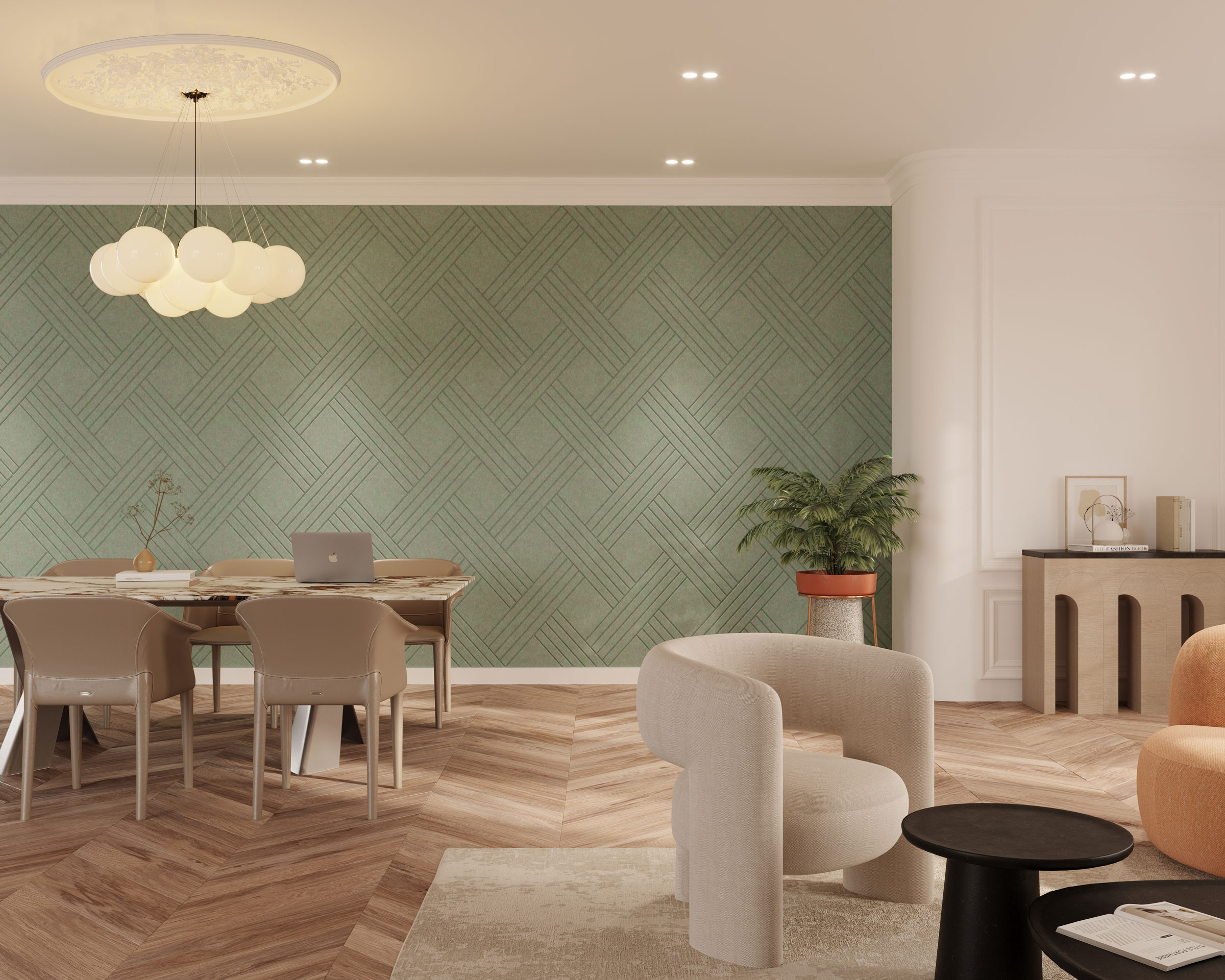 A modern living room features a chevron-patterned wooden floor and a green geometrically patterned accent wall enhanced with acoustic felt wall panels. The space includes a dining table with beige chairs, a laptop, a light grey armchair, an orange sofa, a black coffee table, and a potted plant.