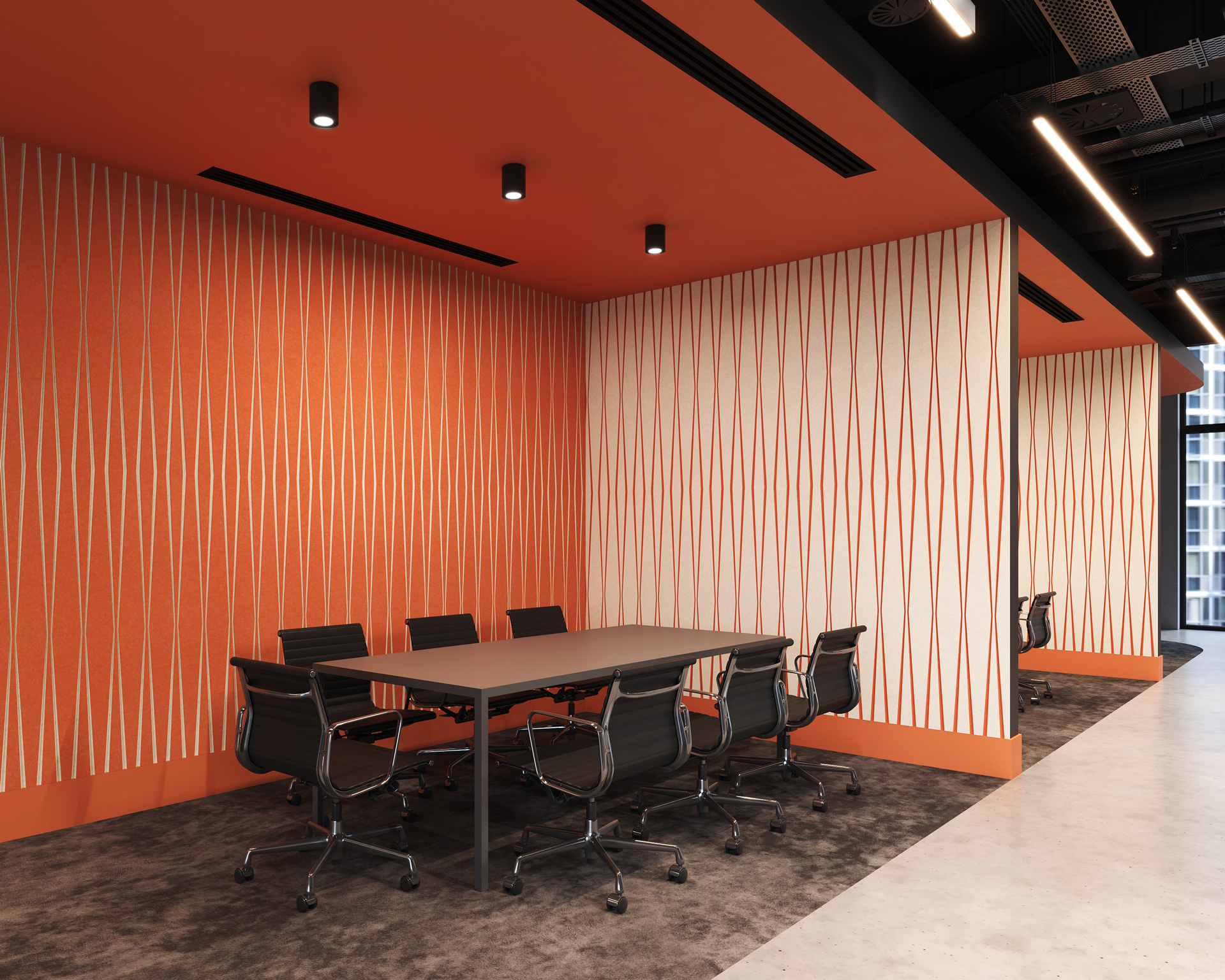 A modern conference room features a long table surrounded by black office chairs. The walls, adorned with vertical orange and beige striped acoustic felt wall panels that match the orange ceiling and part of the floor. Overhead, several black track lights are installed.