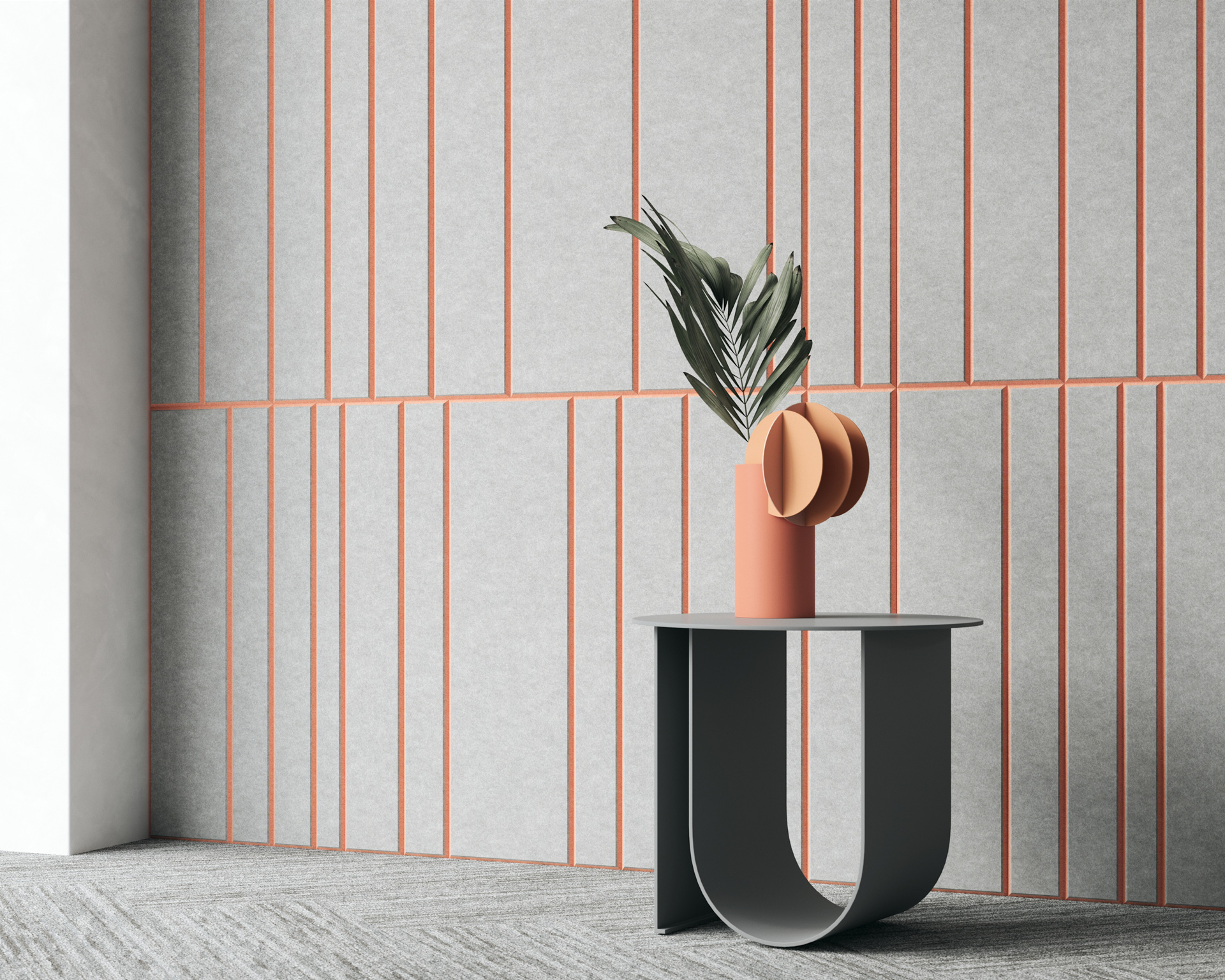 A minimalist room features a sleek, modern table with a unique U-shaped base. On the table sits a geometric vase holding a single palm leaf. The backdrop showcases gray acoustic felt wall panels adorned with vertical and diagonal pink lines. The floor is covered in gray carpet.