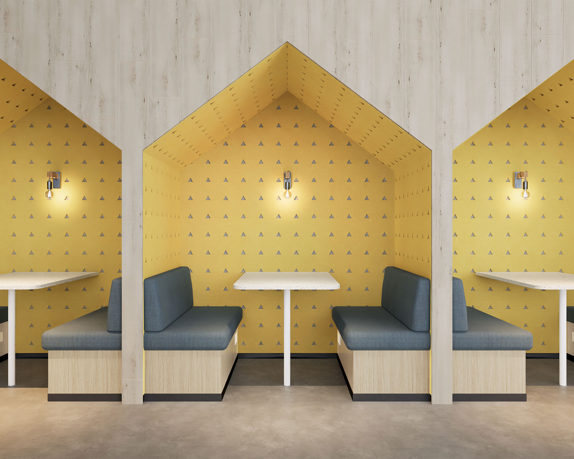 A modern seating area featuring three wooden booths with arch-shaped entrances, each containing a white table and blue cushioned benches. The wall behind the booths is adorned with yellow triangle acoustic felt wall panels. Industrial-style lights hang above each table.