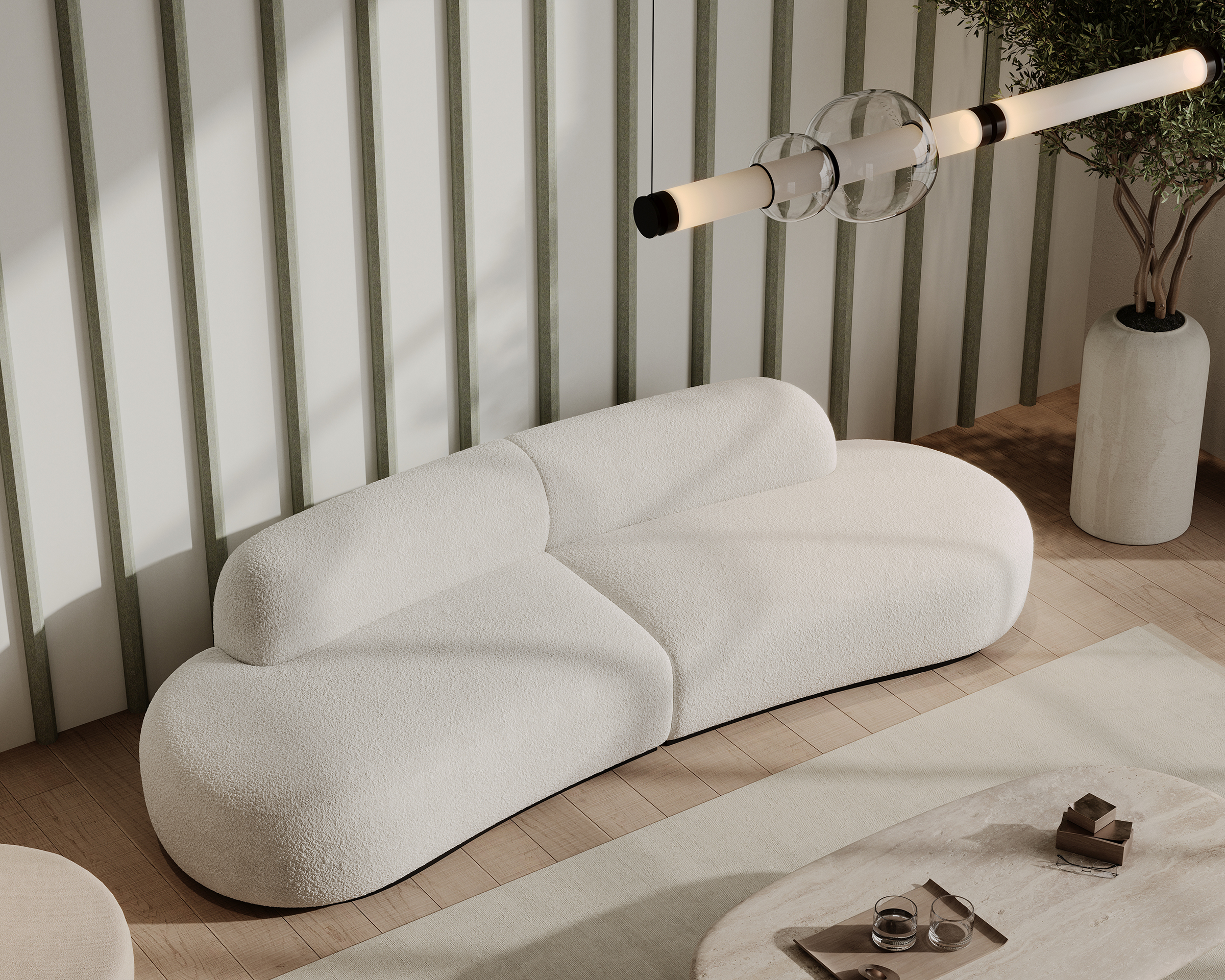 A modern living room features a white, curved sofa with a minimalist design and sleek fabric. Overhead is a contemporary light fixture with tubular bulbs. The room is accented with vertical acoustic wall panels, a neutral-toned rug, a coffee table with decor, and a tall potted plant.