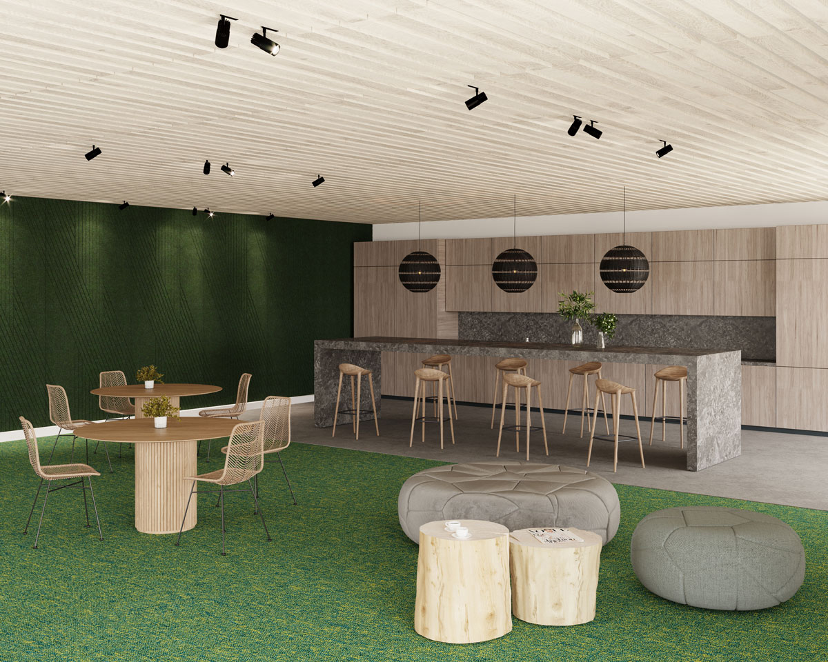 A modern office lounge area featuring a round table with four chairs, two cylindrical wooden stools, ottomans, and a bar counter with four stools. The space combines a green carpet, green wall, and wood-paneled ceiling. An acoustic felt ceiling frame enhances the ambiance alongside hanging spherical lights over the counter.