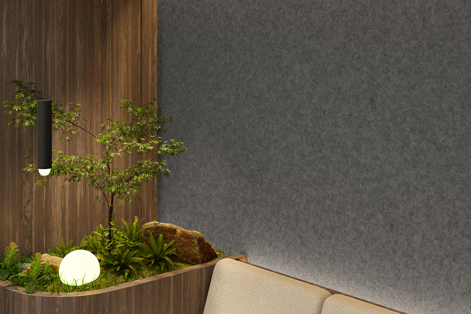 A cozy indoor space featuring a wooden planter with small leafy green plants, rocks, and a glowing spherical light. A dark modern pendant light hangs above them. The background includes a gray acoustic felt wall and the corner of a beige cushioned seat.
