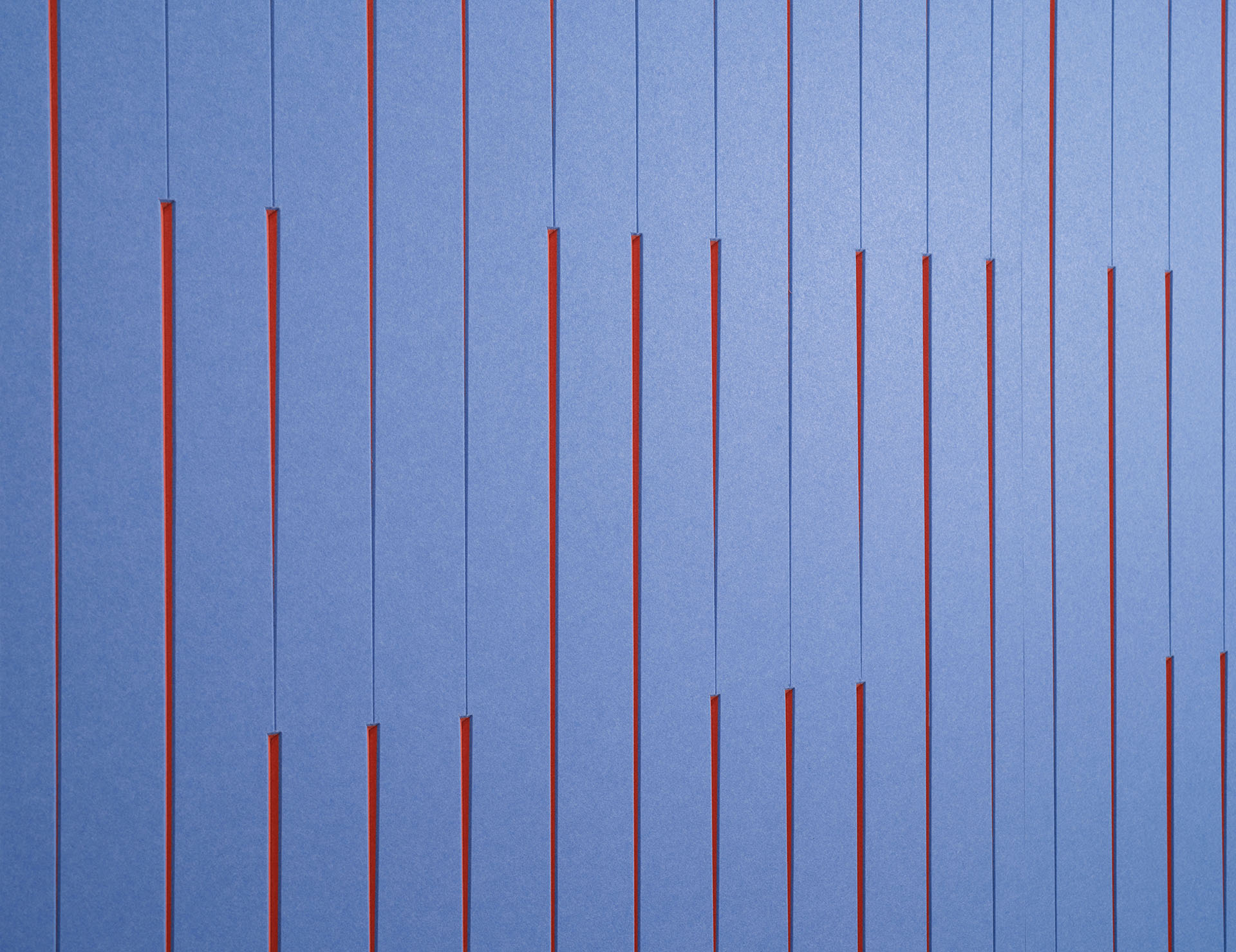 A geometric abstract art piece featuring vertical blue and orange lines. The blue lines are evenly spaced with varying lengths, revealing underlying orange strips in between. The overall design creates a visually striking alternating pattern.