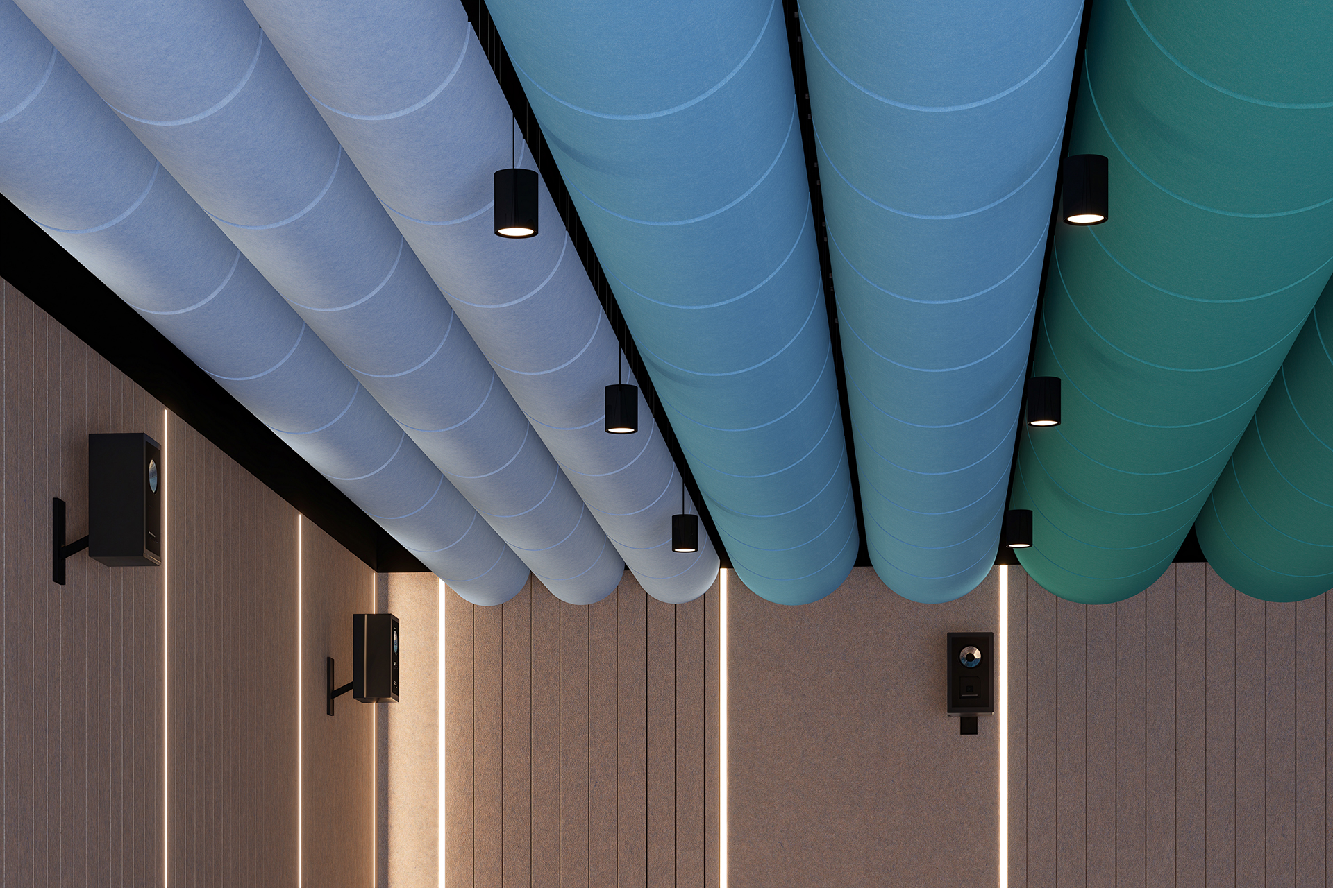 Ceiling view of a modern room with large acoustic felt cylindrical clouds in shades of blue and teal, evenly spaced. Several black cylindrical lights are attached to the ceiling. The walls are lined with vertical panels, and there are black speakers mounted.
