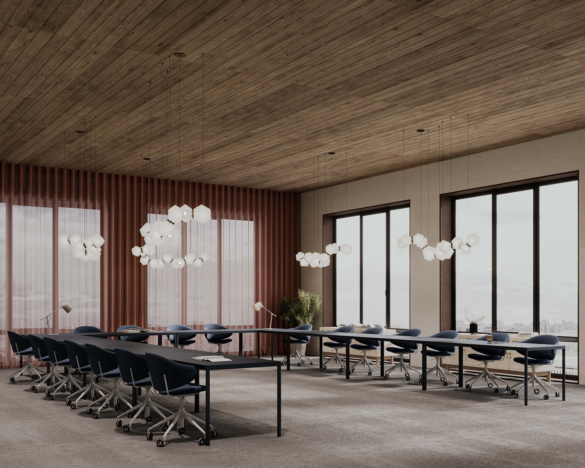 Spacious conference room with an elegant woodgrain acoustic felt ceiling and floor-to-ceiling windows. Long tables are surrounded by blue chairs on wheels. Pendant lights hang from above, and a red curtain and plant are in the corner, enhancing the charm of this modern space.