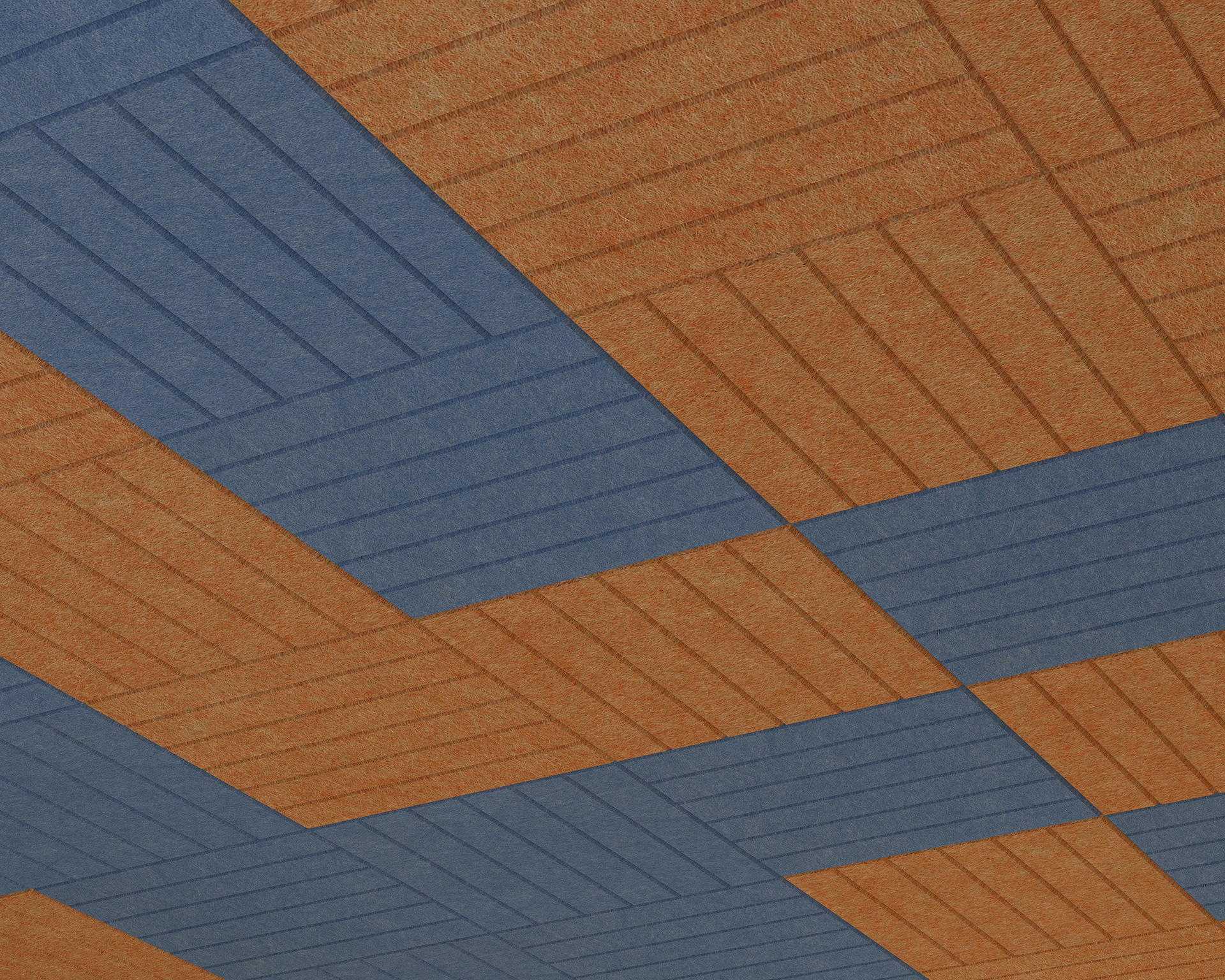 A geometric ceiling pattern featuring rows of interlocking orange and blue rectangular acoustic felt panels arranged diagonally. These acoustic felt ceiling panels have a textured finish, creating a modern, abstract design through their horizontal and vertical orientations.