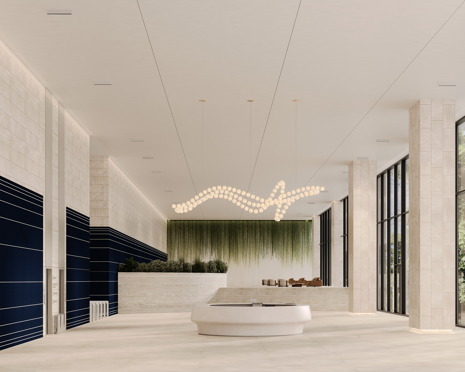 A modern lobby with a large, abstract chandelier hanging from the ceiling. The room features tall windows, white tile flooring, dark blue acoustic felt accent walls, and a central, circular reception desk. Greenery adorns the wall behind the desk.