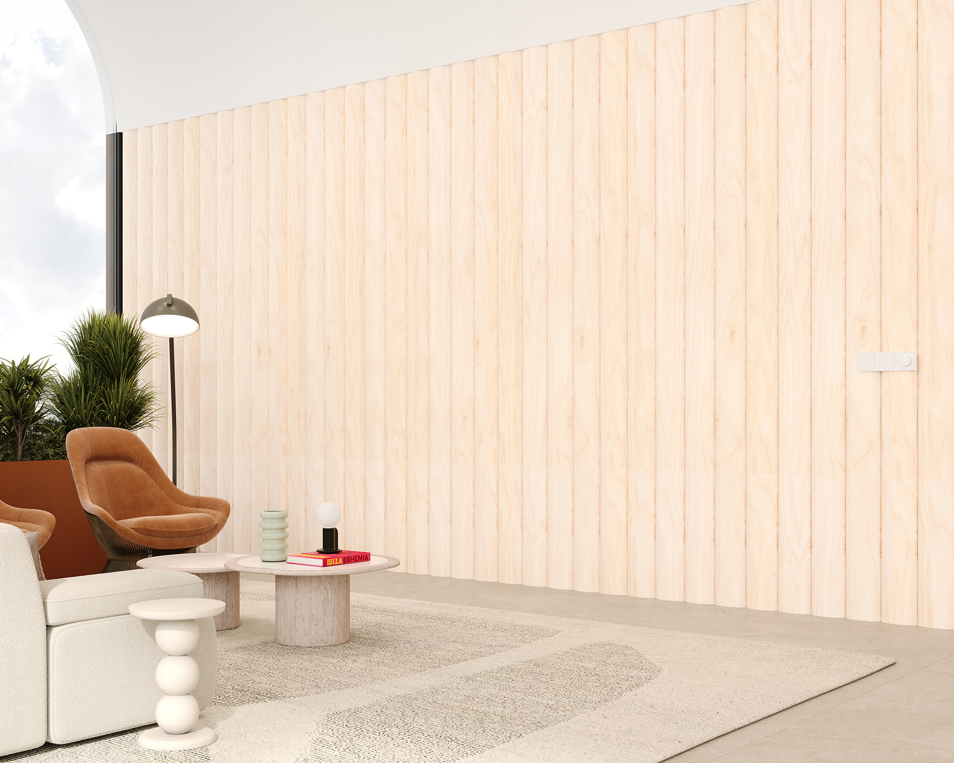 Modern living room with light woodgrain acoustic paneled walls and a large window. A beige sofa and brown armchair are paired with a round pink table. A floor lamp and potted plants add to the decor. A light rug covers part of the concrete floor.