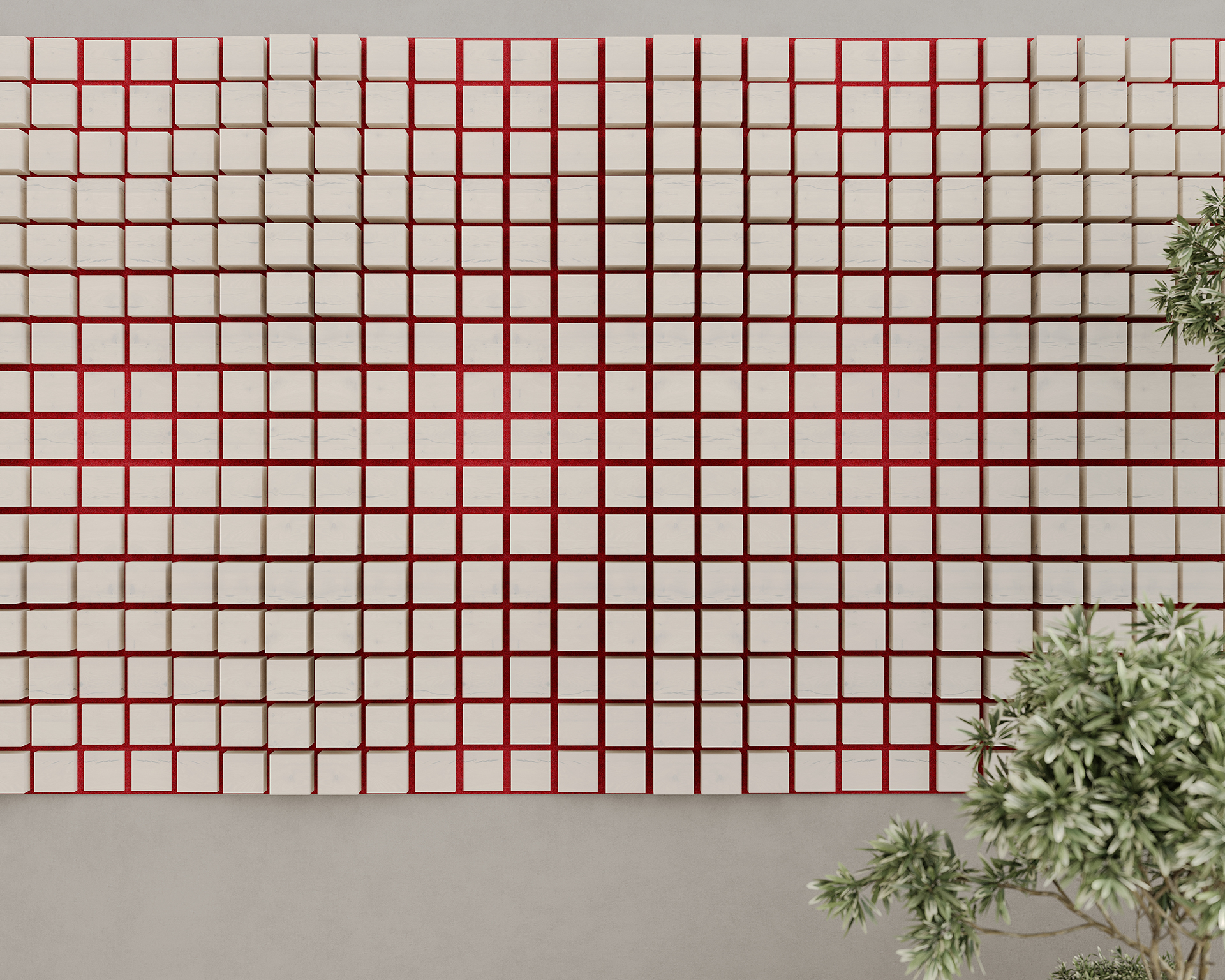A tiled wall art installation featuring a geometric acoustic felt pattern of small, square tiles with red grid lines creating symmetry. The art is mounted on a gray background, with some greenery visible at the lower right corner.