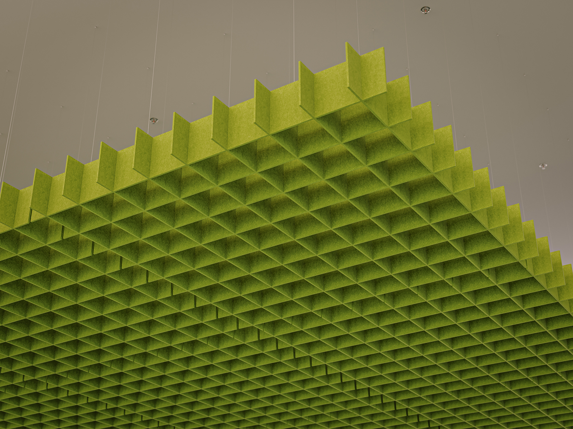 A suspended green acoustic felt ceiling panel with a grid pattern hangs from a light gray ceiling, creating a modern, geometric look.